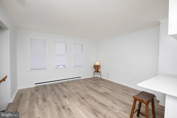 a room with a wooden floor and cabinets