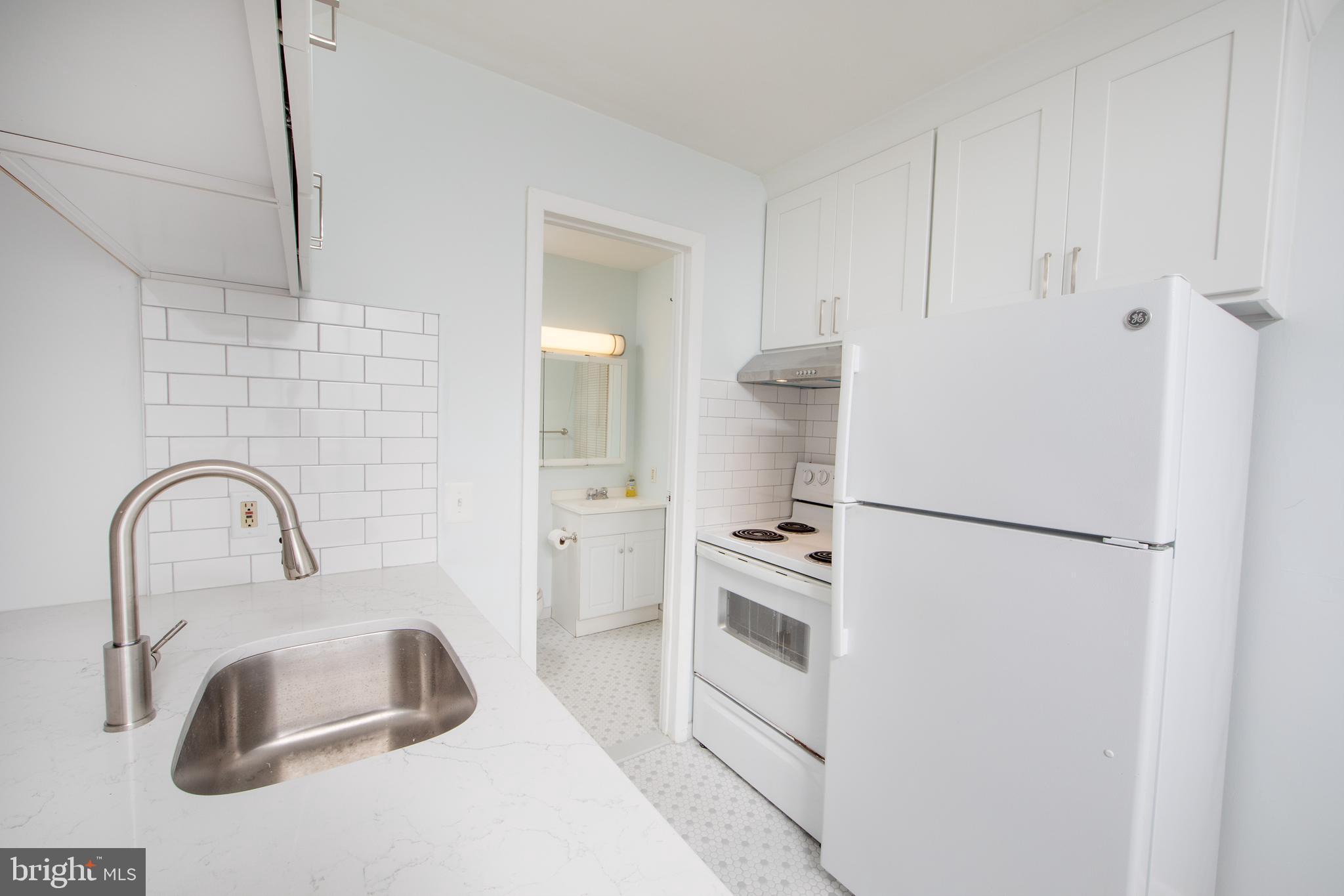 129 South Main Street, Unit A New Hope, PA 18938 - Photo 5 of 8 a close view of a sink and a refrigerator in a kitchen
