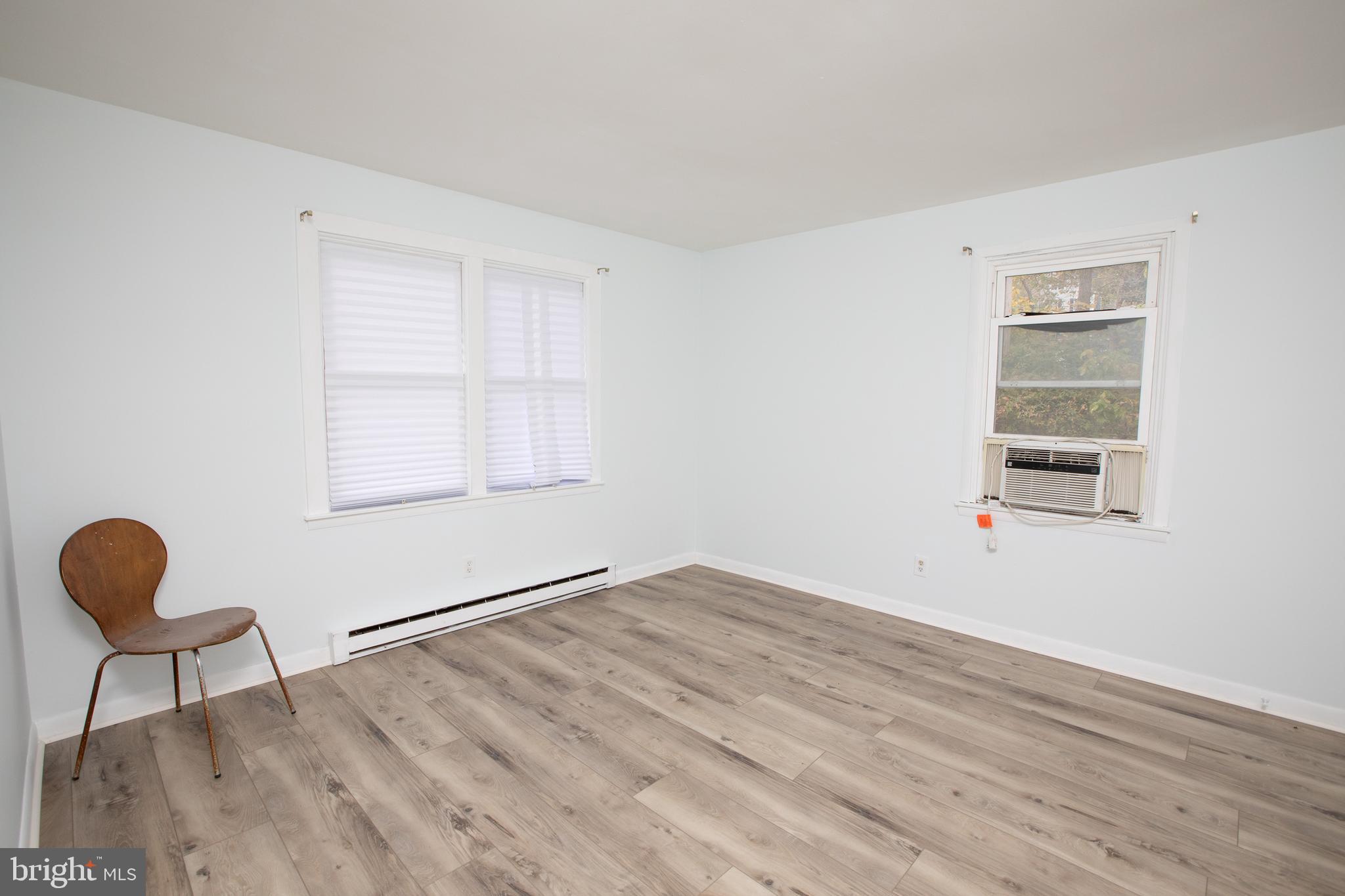 129 South Main Street, Unit A New Hope, PA 18938 - Photo 7 of 8 a view of an empty room with wooden floor and a window