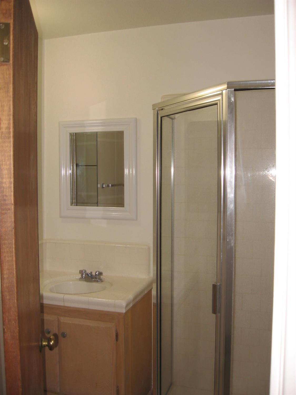 40658 Cherokee Oaks Drive Three Rivers, CA 93271 - Photo 21 of 25 a bathroom with a sink and mirror