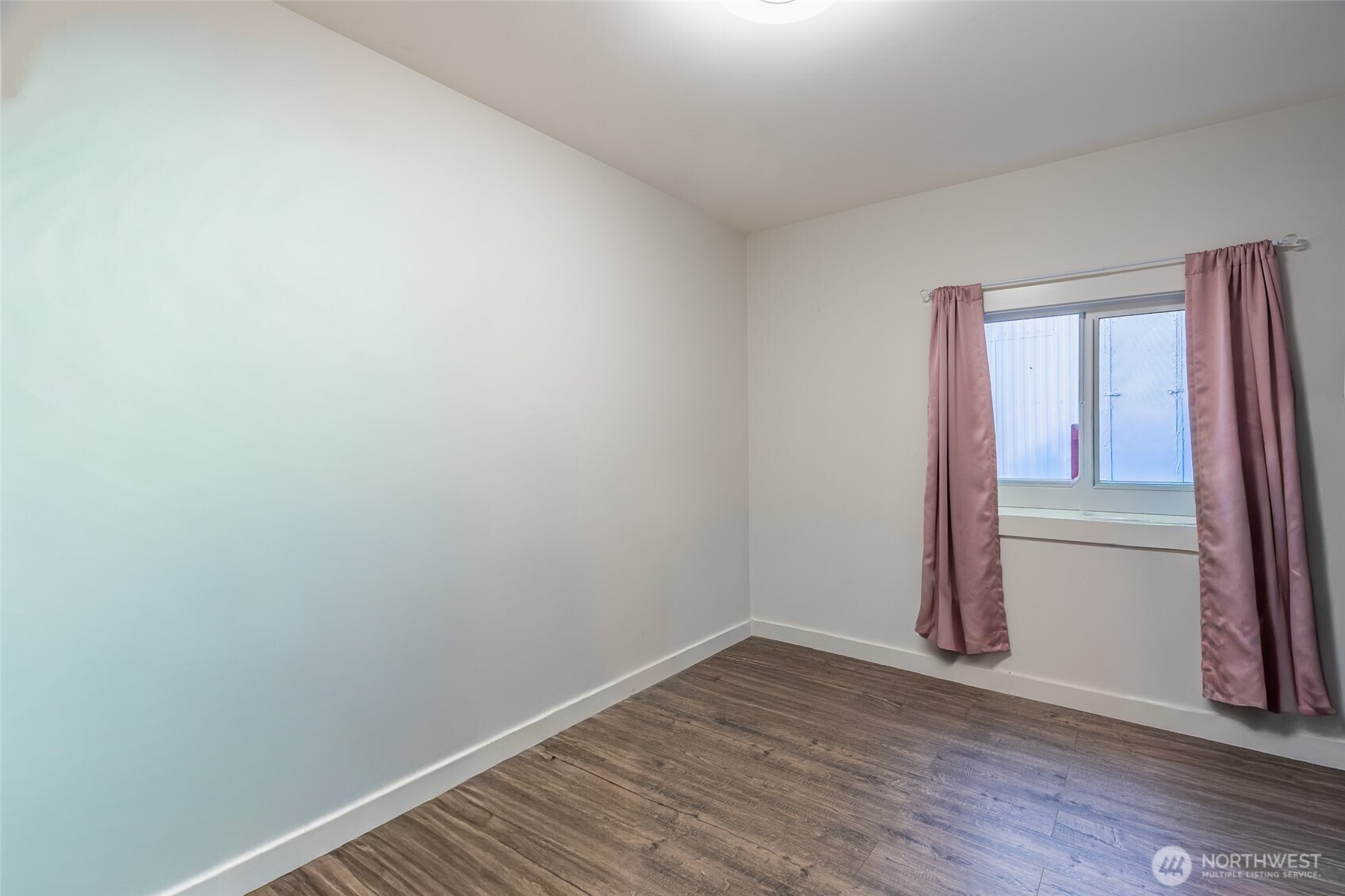 16405 Maple Valley Highway, Unit 22 Renton, WA 98058 - Photo 16 of 31 a view of a small space with wooden floor and a window