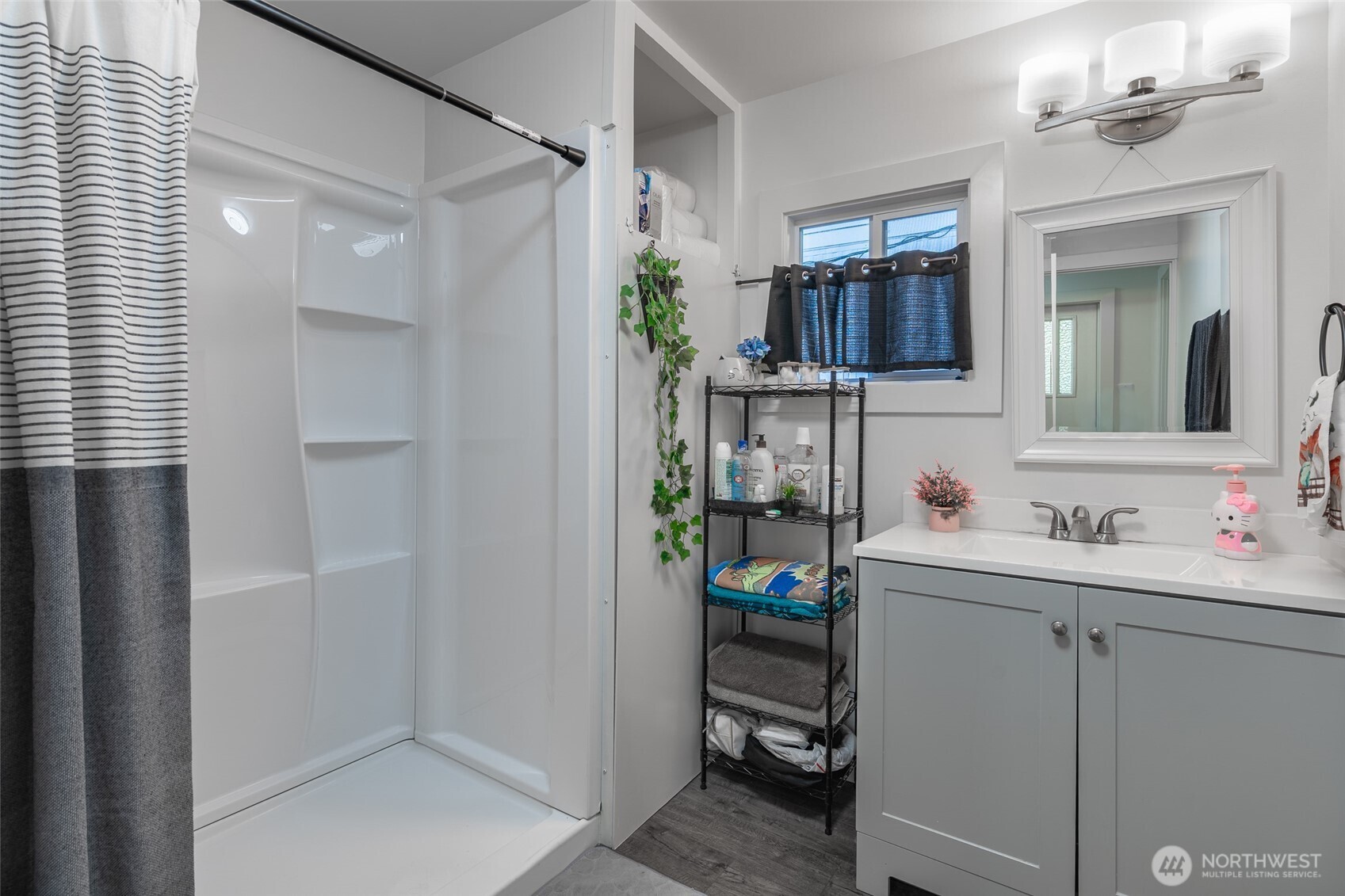 16405 Maple Valley Highway, Unit 22 Renton, WA 98058 - Photo 18 of 31 a bathroom with a sink and a mirror