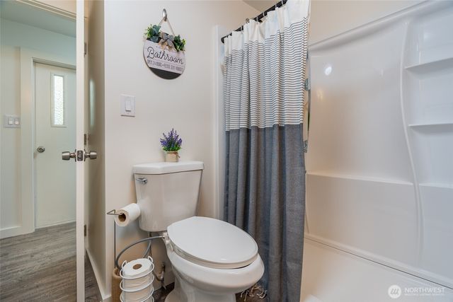 a bathroom with a toilet a sink and tub