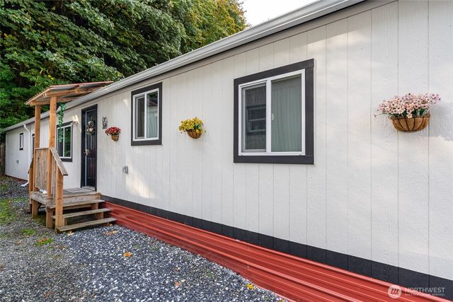 a view of a small house with wooden floor and fence
