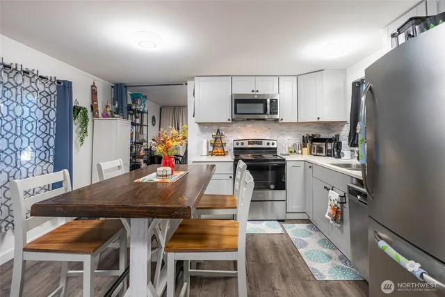 a kitchen with stainless steel appliances granite countertop a stove refrigerator sink and cabinets