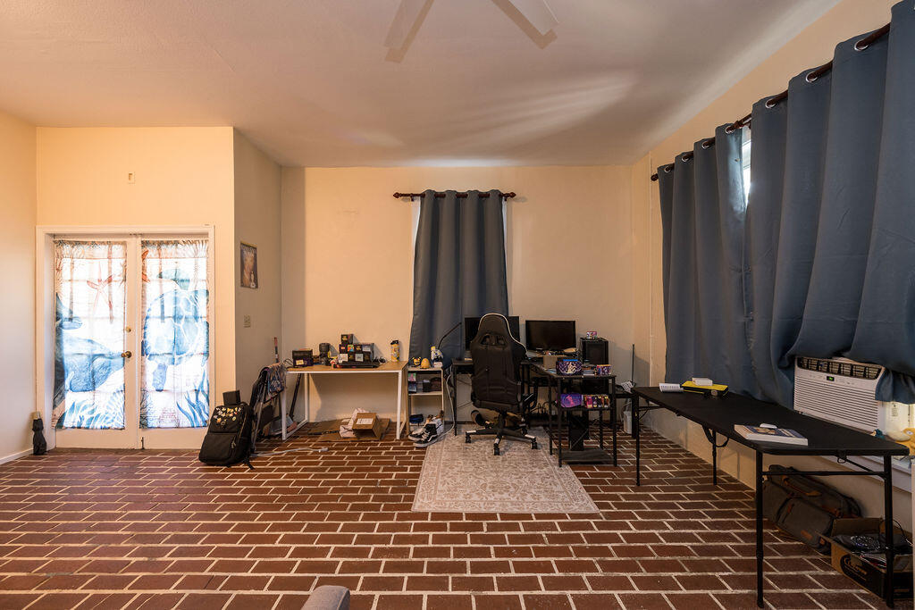 905 Grinnell Street Key West, FL 33040 - Photo 12 of 19 a living room with furniture a large window and chair