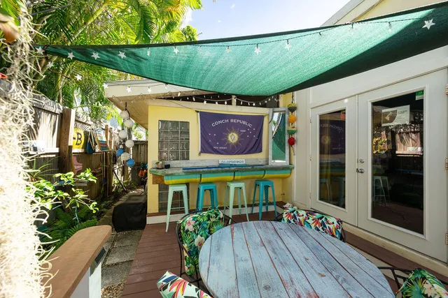 a view of a chairs and table in the balcony