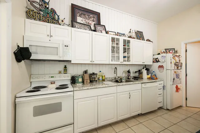 a kitchen with stainless steel appliances granite countertop a sink and cabinets