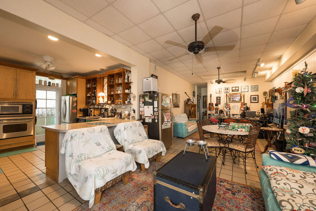 905 Grinnell Street Key West, FL 33040 - Photo 5 of 19 a living room with lots of furniture and kitchen view