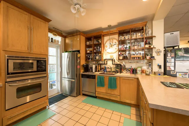 a kitchen with stainless steel appliances granite countertop a stove a sink and a refrigerator