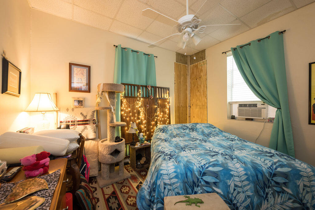 905 Grinnell Street Key West, FL 33040 - Photo 7 of 19 a bedroom with a bed and a chandelier