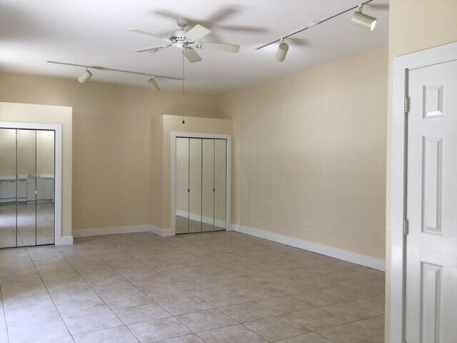 905 Grinnell Street Key West, FL 33040 - Photo 10 of 19 en empty room with a mirror and a fan