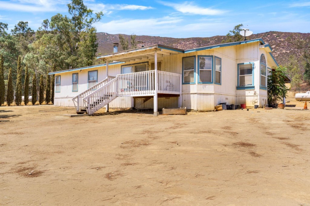 a view of a house with a snow in the yard