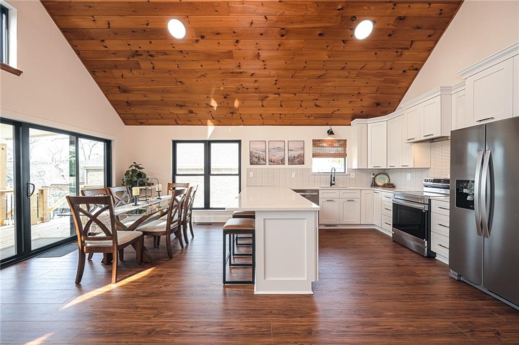3339 Cove Overlook Road Gainesville, GA 30501 - Photo 11 of 67 a kitchen with stainless steel appliances granite countertop a table chairs stove and kitchen view