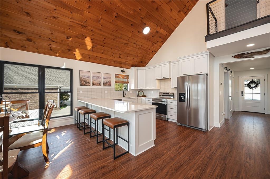 3339 Cove Overlook Road Gainesville, GA 30501 - Photo 12 of 67 a kitchen with stainless steel appliances granite countertop wooden floors a refrigerator and a stove