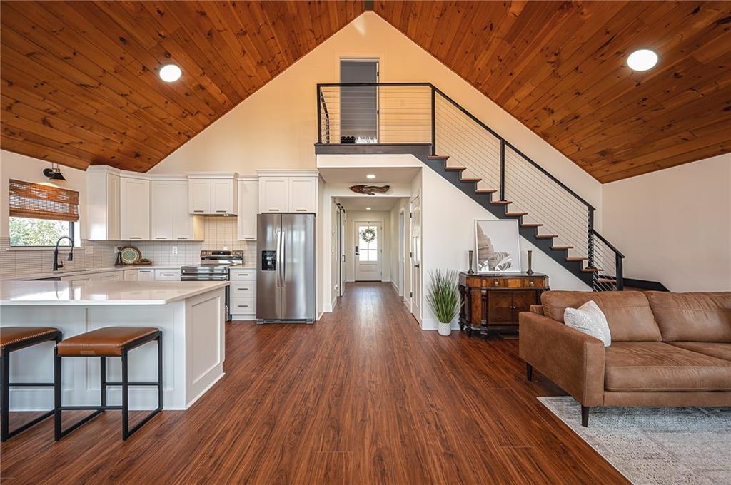 3339 Cove Overlook Road Gainesville, GA 30501 - Photo 15 of 67 a view of a living room with wooden floors and kitchen view