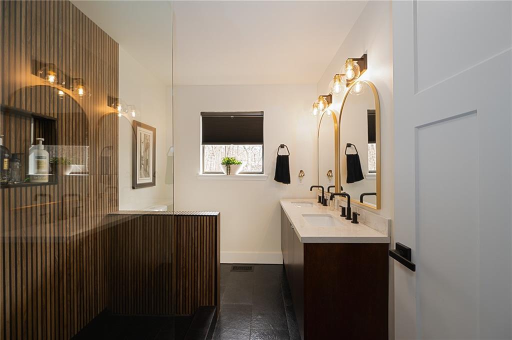 3339 Cove Overlook Road Gainesville, GA 30501 - Photo 21 of 67 a bathroom with a sink a mirror and shower