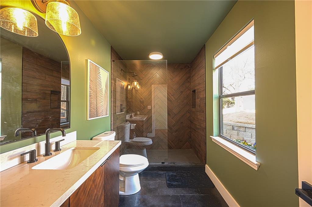 3339 Cove Overlook Road Gainesville, GA 30501 - Photo 27 of 67 a bathroom with a granite countertop sink toilet and shower
