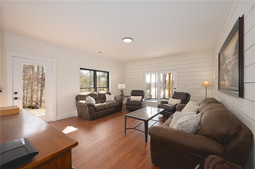 3339 Cove Overlook Road Gainesville, GA 30501 - Photo 30 of 67 a living room with furniture and wooden floor