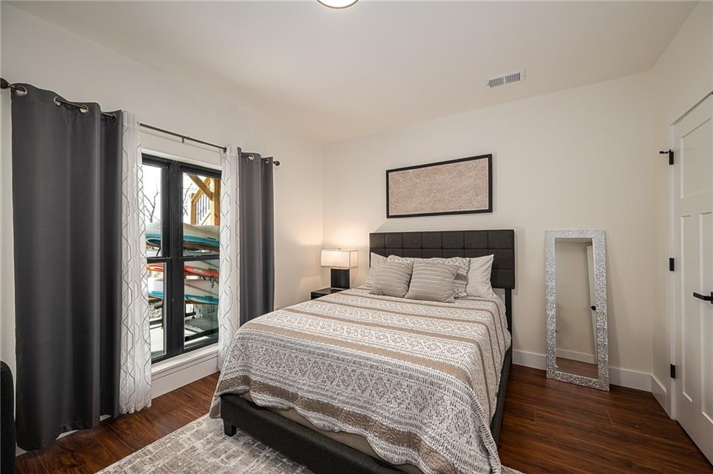 3339 Cove Overlook Road Gainesville, GA 30501 - Photo 32 of 67 a bedroom with a bed a dresser and a window