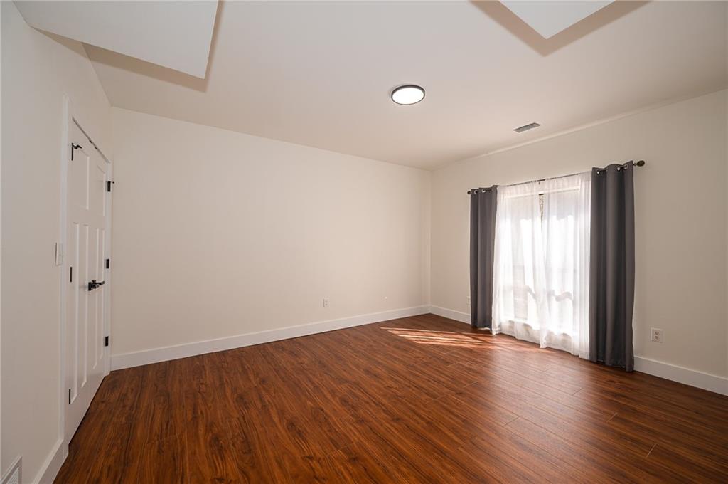 3339 Cove Overlook Road Gainesville, GA 30501 - Photo 35 of 67 an empty room with wooden floor and windows
