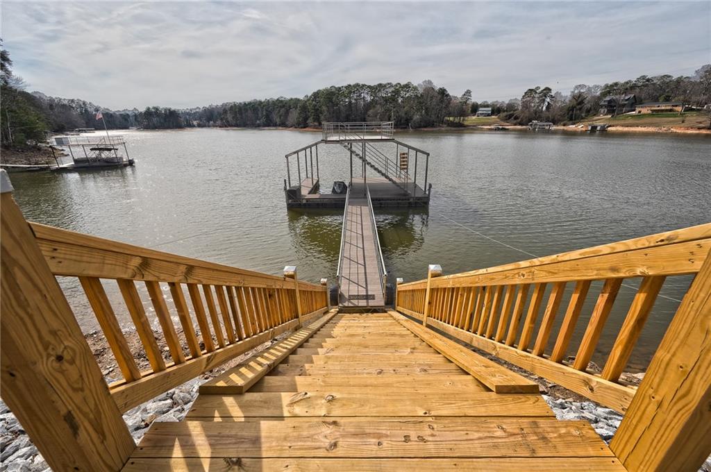 3339 Cove Overlook Road Gainesville, GA 30501 - Photo 41 of 67 a view of wooden balcony with lake and houses in the back