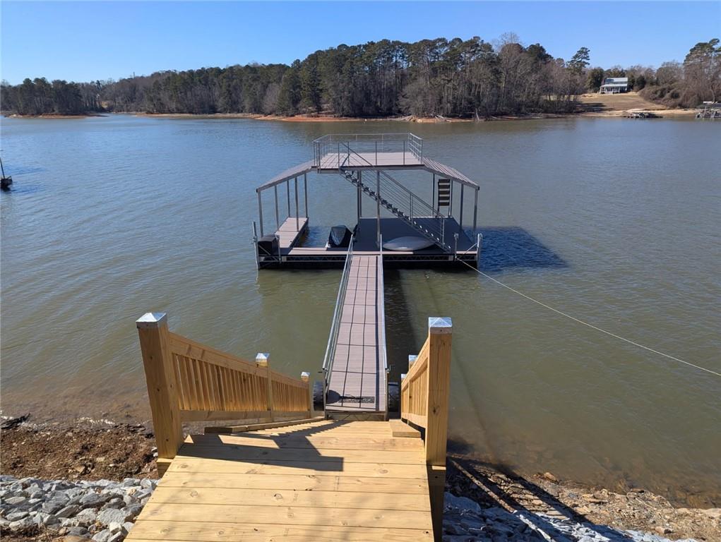 3339 Cove Overlook Road Gainesville, GA 30501 - Photo 42 of 67 a view of a lake with a wooden deck