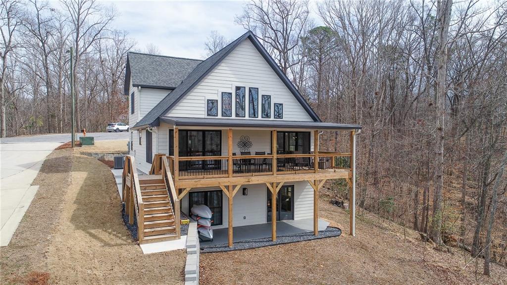 3339 Cove Overlook Road Gainesville, GA 30501 - Photo 56 of 67 a view of a house with a yard and balcony