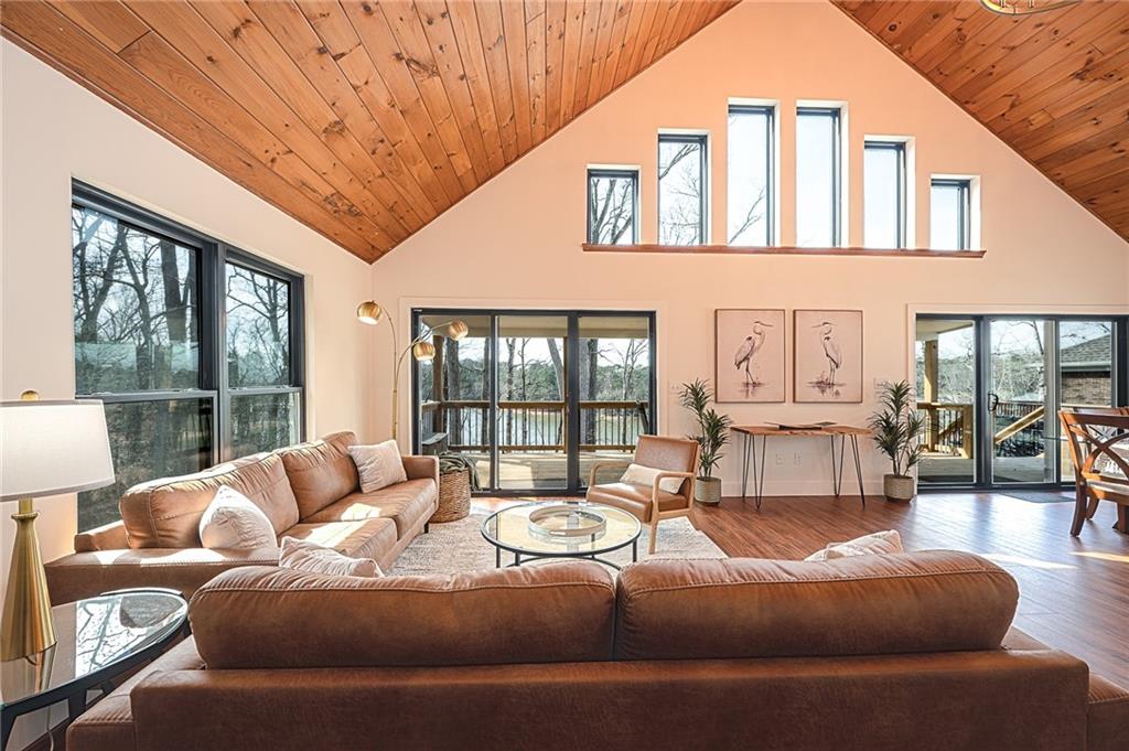 3339 Cove Overlook Road Gainesville, GA 30501 - Photo 10 of 67 a living room with furniture large windows and wooden floor
