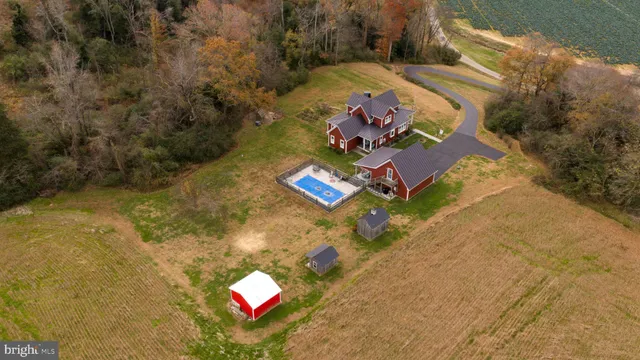 a view of a house with floor to ceiling windows and a lawn chair