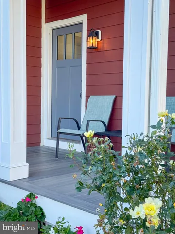 a view of hall way with furniture and chandelier