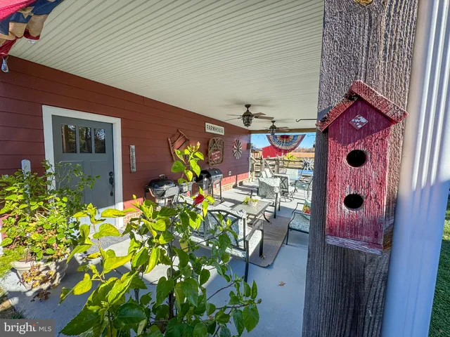a living room with furniture kitchen view and a rug