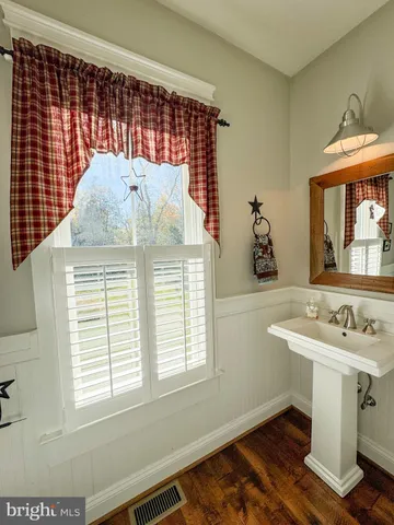 a view of walk in closet with window and wooden floor