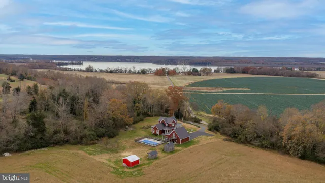 a aerial view of a house with swimming pool and a yard