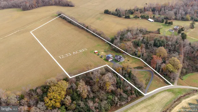 an aerial view of a house with swimming pool and porch