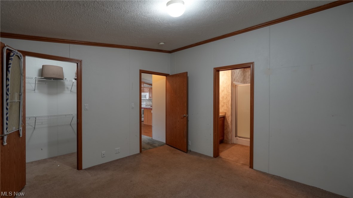 59062 Marietta Road Byesville, OH 43723 - Photo 16 of 33 Unfurnished bedroom with a textured ceiling, light carpet, and a closet