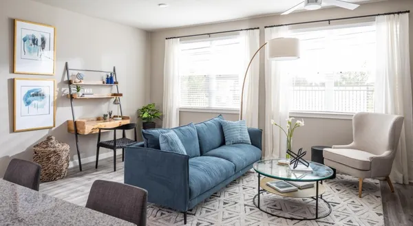 a living room with furniture and a large window