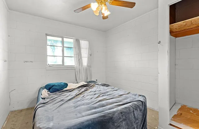 a bedroom with a bed and a chandelier