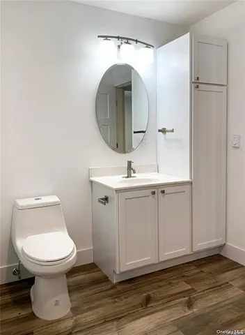 a bathroom with a toilet a sink and mirror