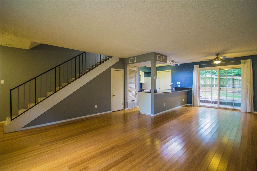 616 Castle Ridge Road, Unit C Austin, TX 78746 - Photo 1 of 1 a view of an empty room with wooden floor and a window