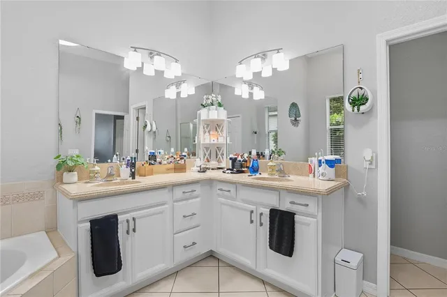 a kitchen with kitchen island granite countertop a sink a stove and cabinets