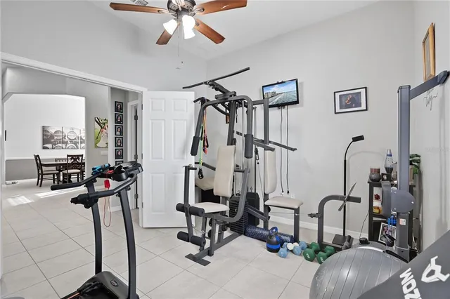 a view of a livingroom with furniture and gym equipment