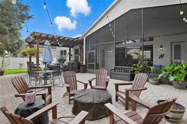 a view of a patio with couches table and chairs and potted plants