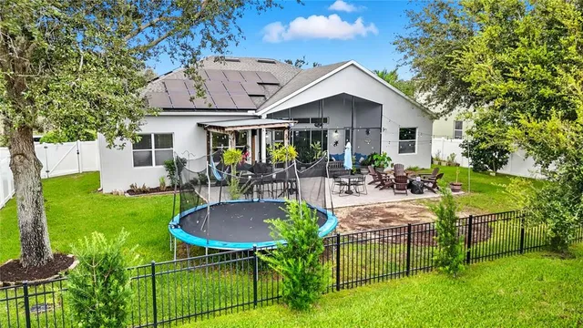 a view of a house with backyard porch and sitting area