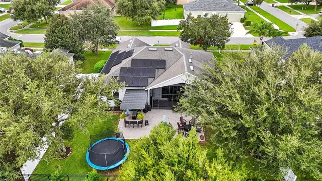 an aerial view of a house with swimming pool yard and outdoor seating