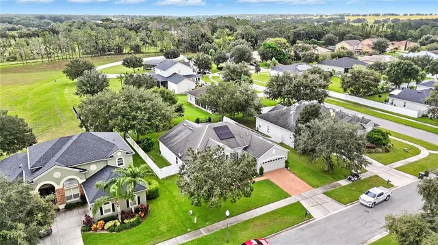 an aerial view of residential houses with outdoor space and street view