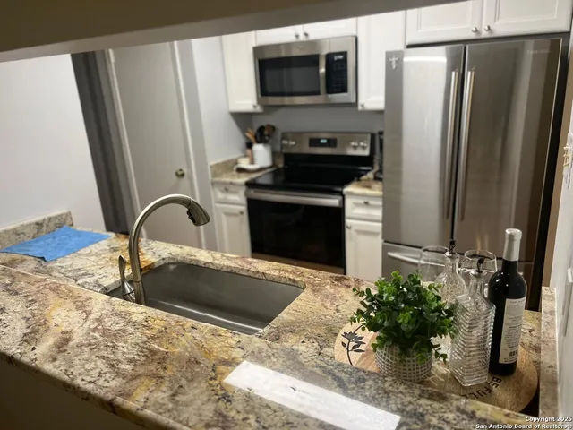 a kitchen with a sink and a refrigerator