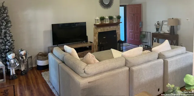 a living room with furniture a flat screen tv and a fireplace