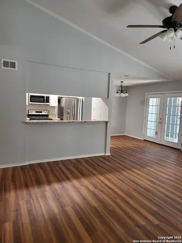 a view of a room with wooden floor
