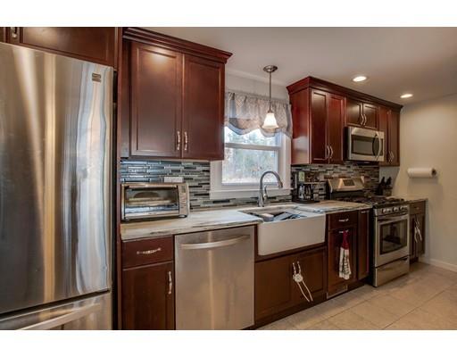 10 Riverside Road Billerica, MA 01821 - Photo 3 of 28 a kitchen with stainless steel appliances granite countertop a refrigerator a stove a sink and a microwave